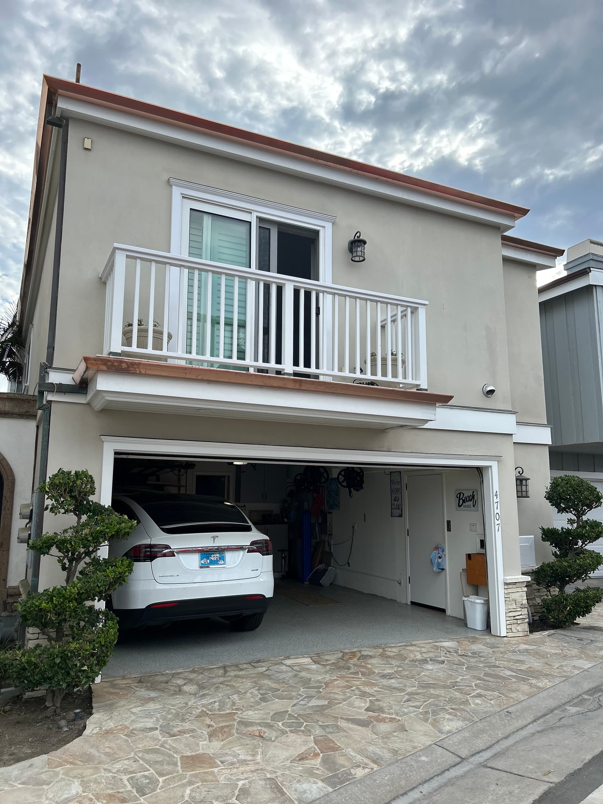 Copper gutter and downspout on a coastal home front elevation