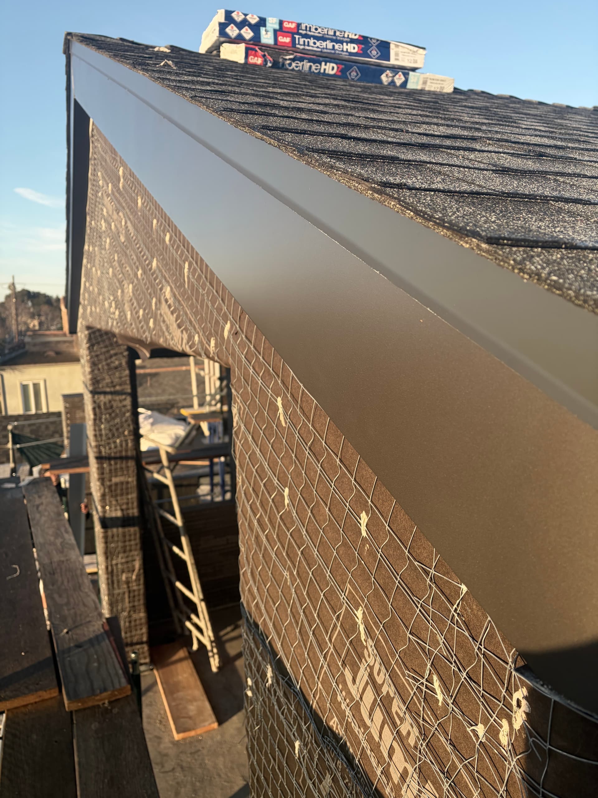 Finished aluminum fascia wrap along shingle roofline on residential home