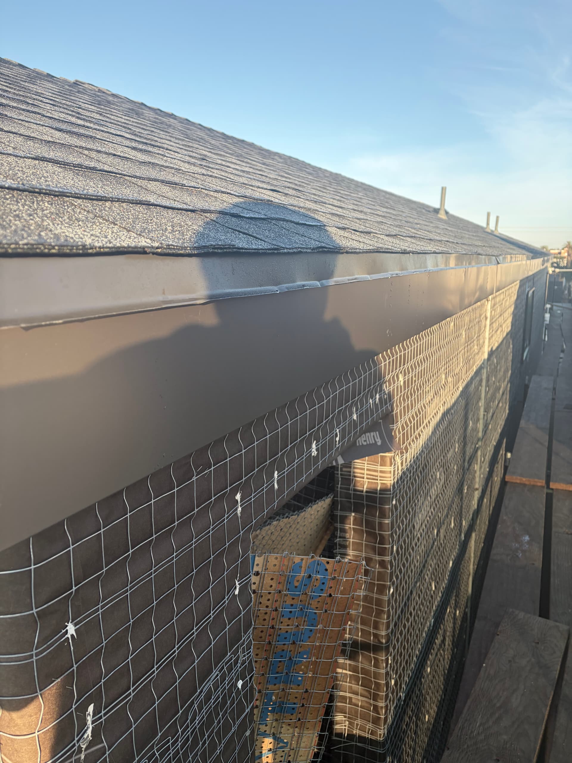 Aluminum fascia wrap integrated with gutter along roofline close-up